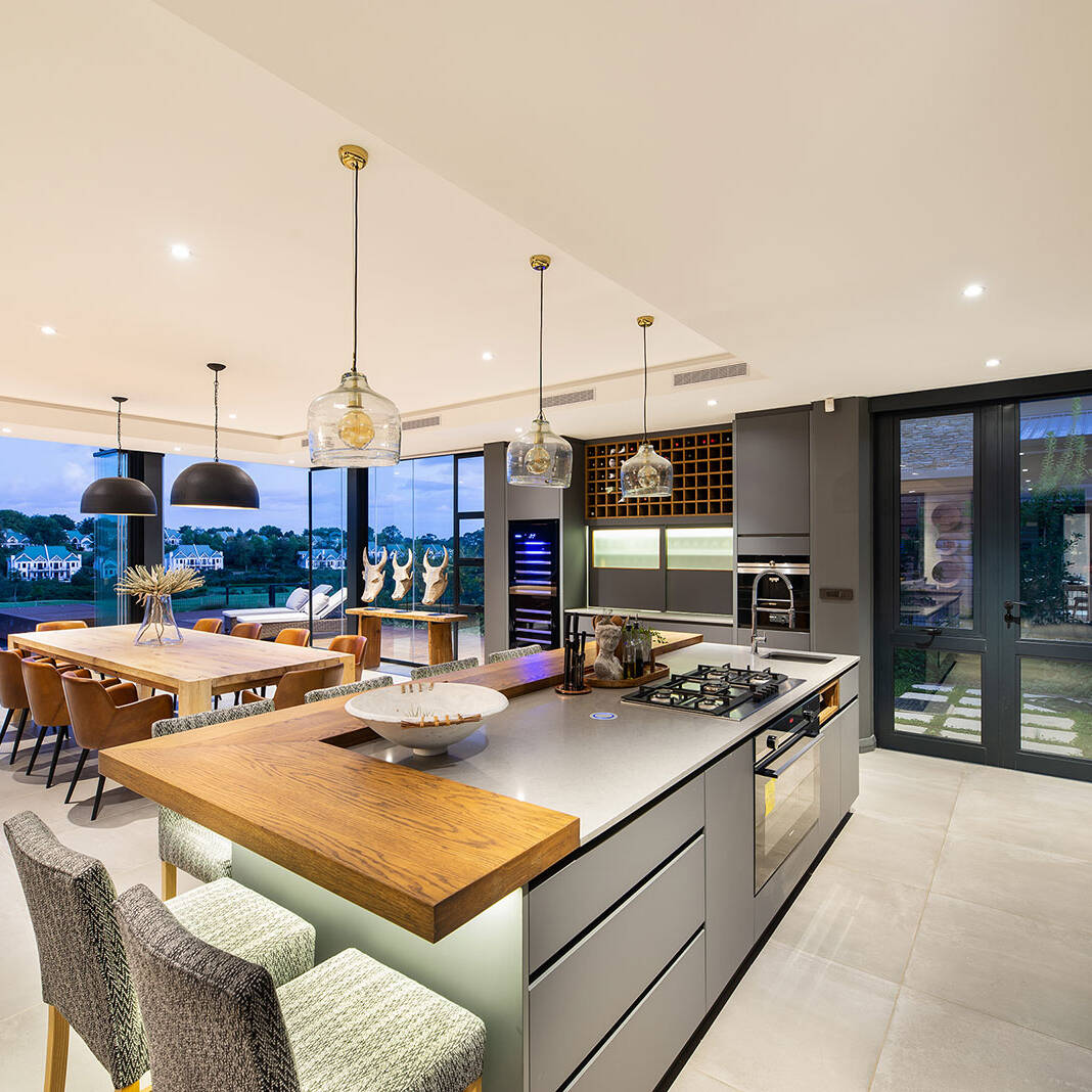 Open plan kitchen and dining area with island seating and pendant lighting