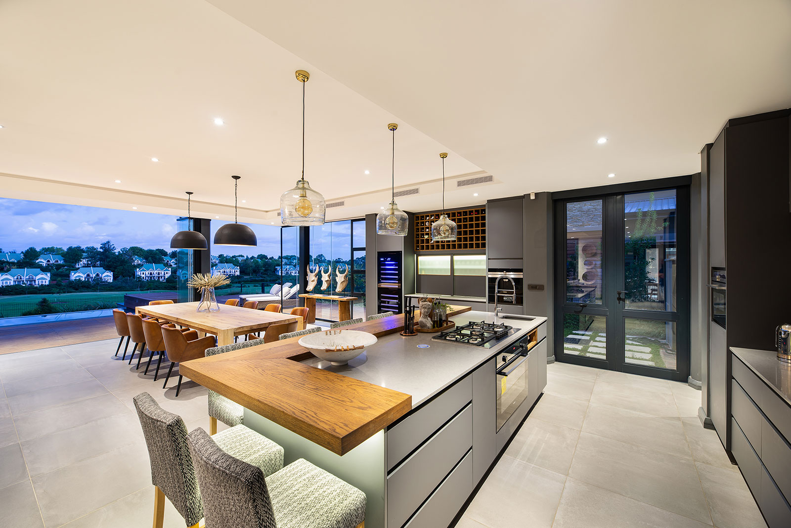 Open plan kitchen and dining area with island seating and pendant lighting