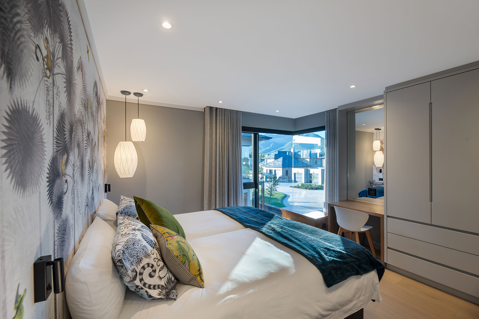 Guest bedroom with bay window and patterned feature wall