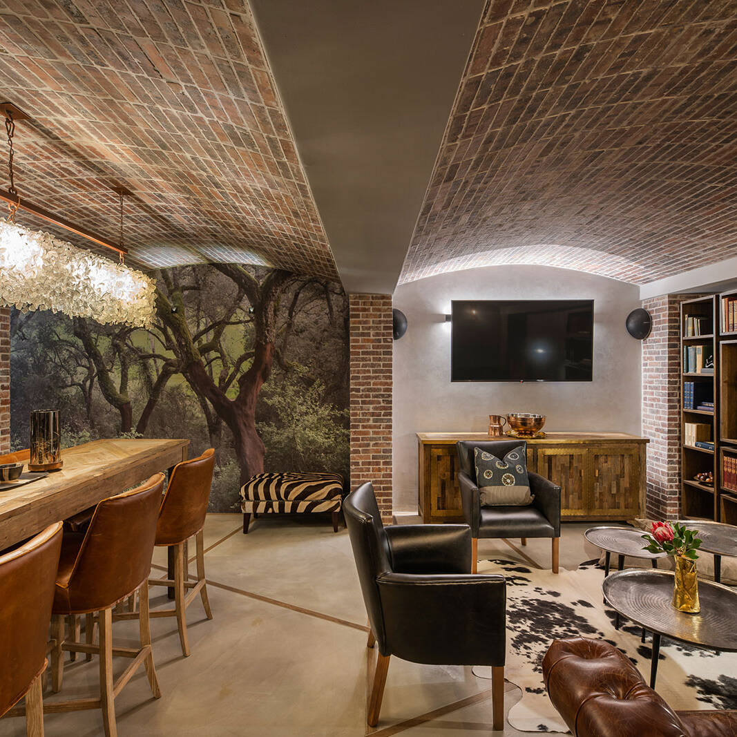Brick vaulted cellar lounge with bar and library shelving
