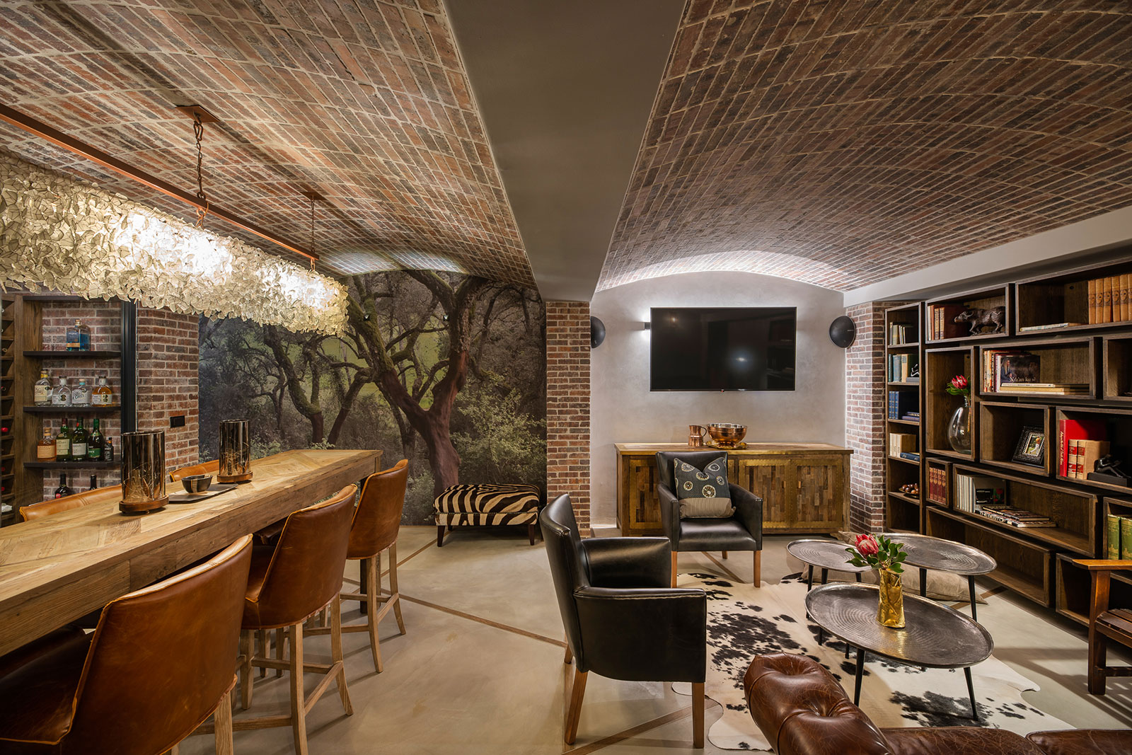 Brick vaulted cellar lounge with bar and library shelving
