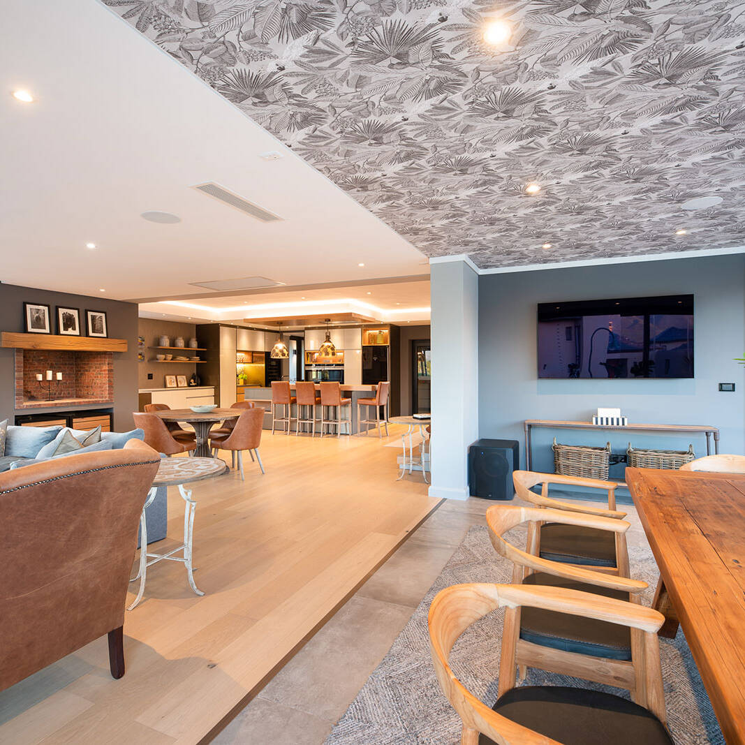 Open plan dining and kitchen with indoor braai and timber finishes