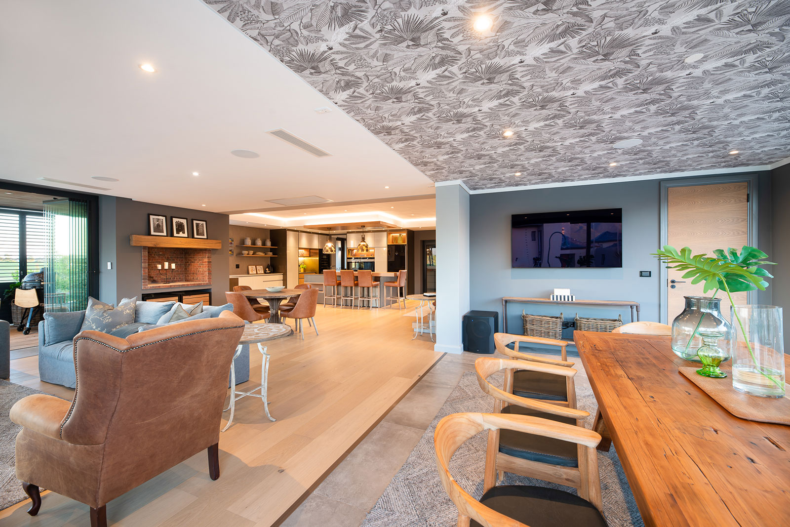 Open plan dining and kitchen with indoor braai and timber finishes