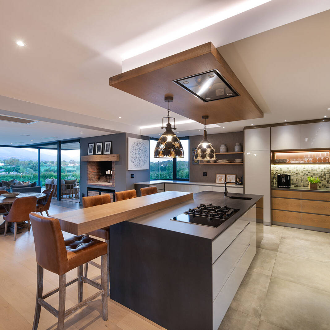 Contemporary kitchen with pendant lighting and views across the estate