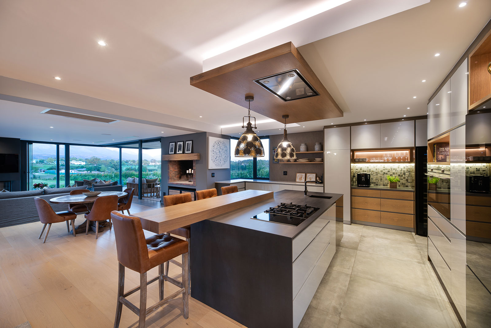 Contemporary kitchen with pendant lighting and views across the estate