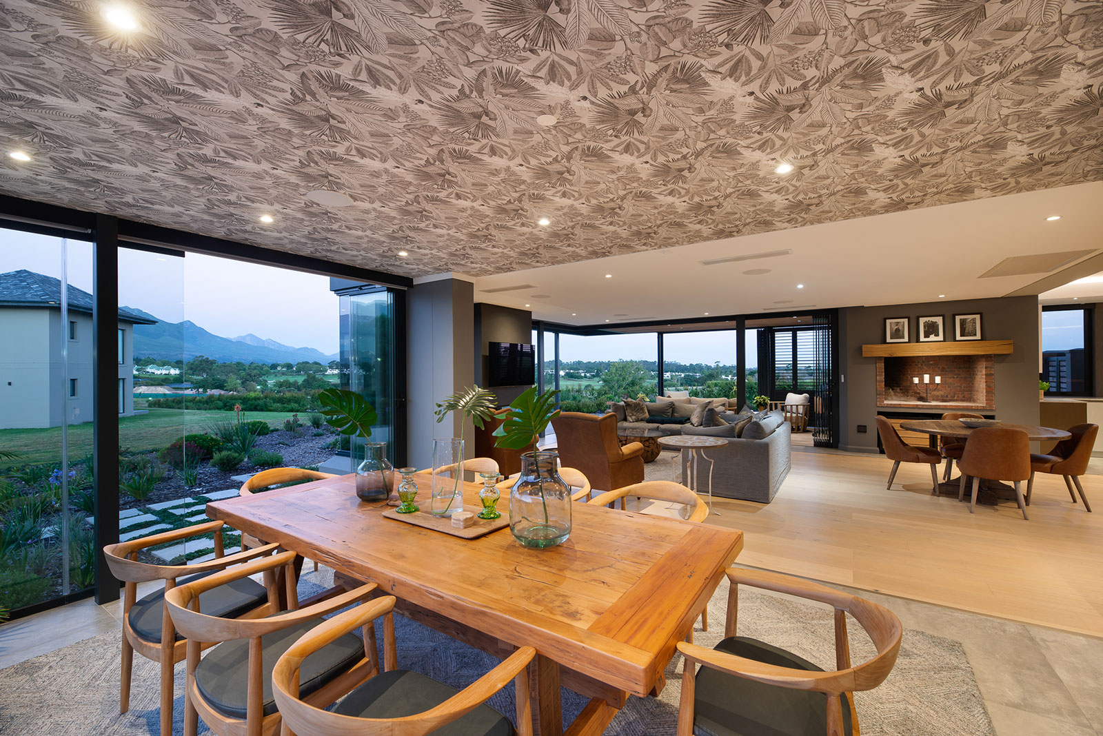 Family living area with patterned ceiling and sliding doors to patio