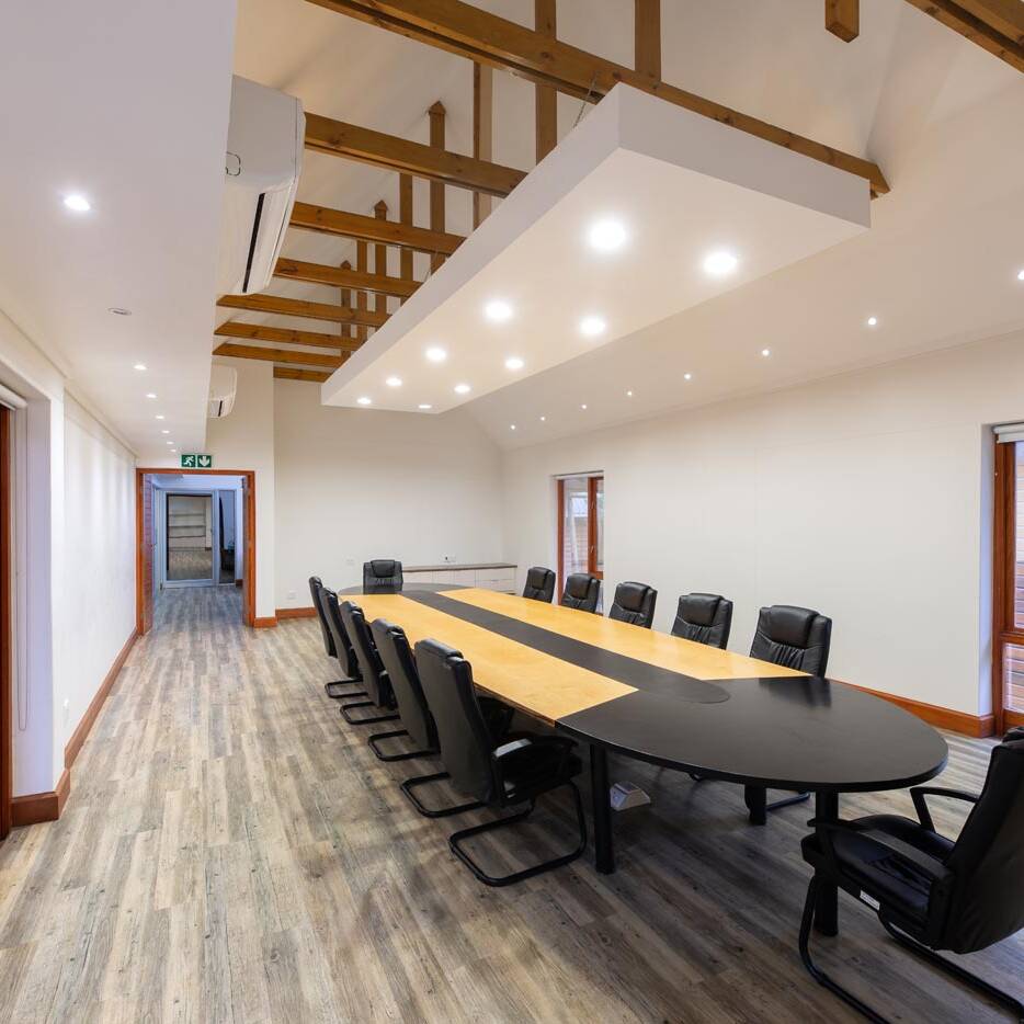 Perspective of meeting room and corridor with visible roof trusses