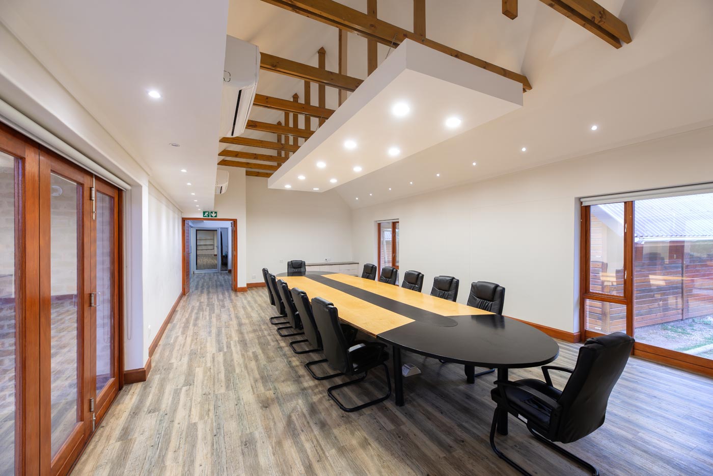 Perspective of meeting room and corridor with visible roof trusses