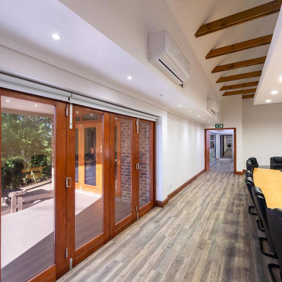 Boardroom opening to glazed timber doors and landscaped veranda