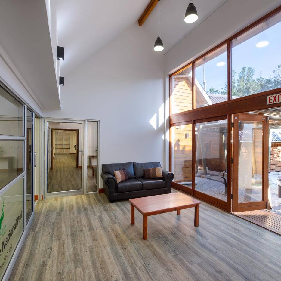 Double volume reception with sofa and full height glazing to courtyard