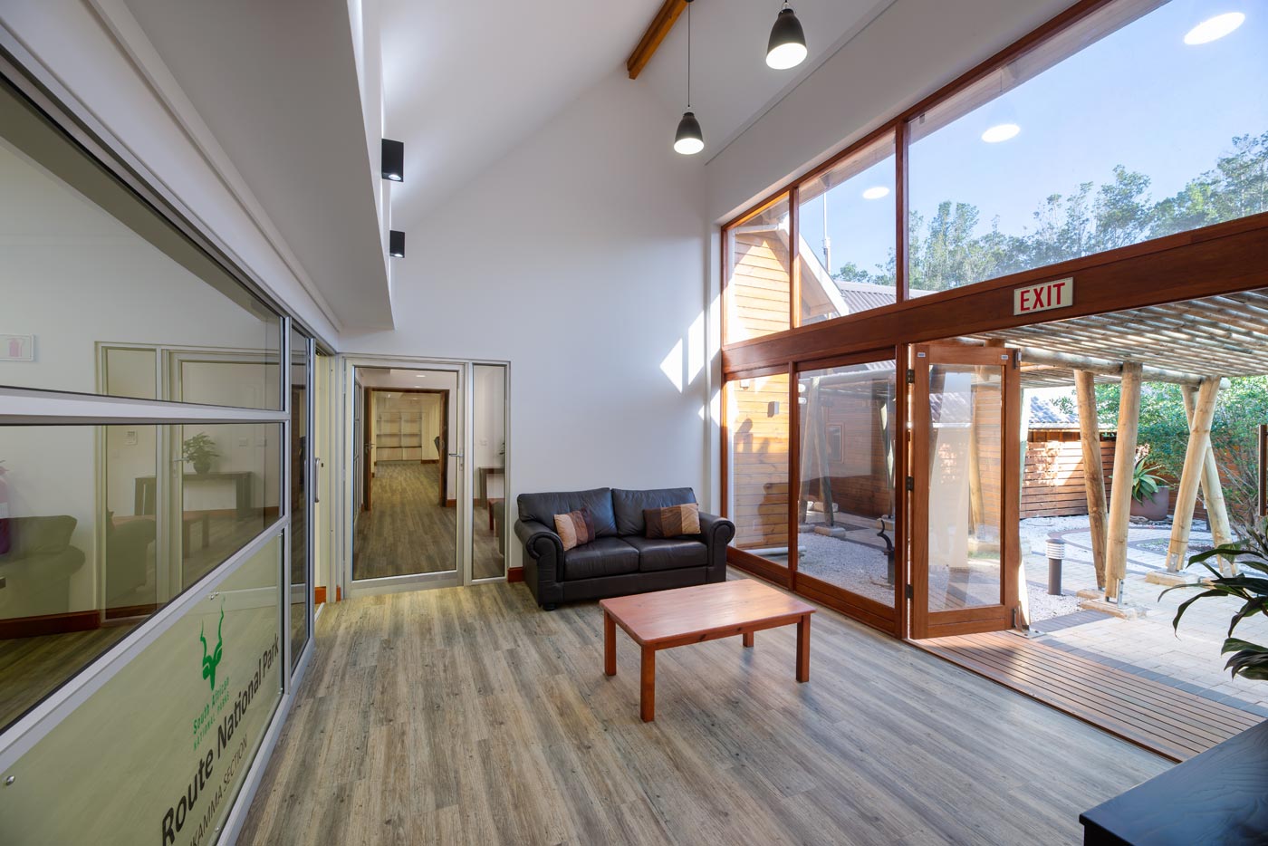 Double volume reception with sofa and full height glazing to courtyard