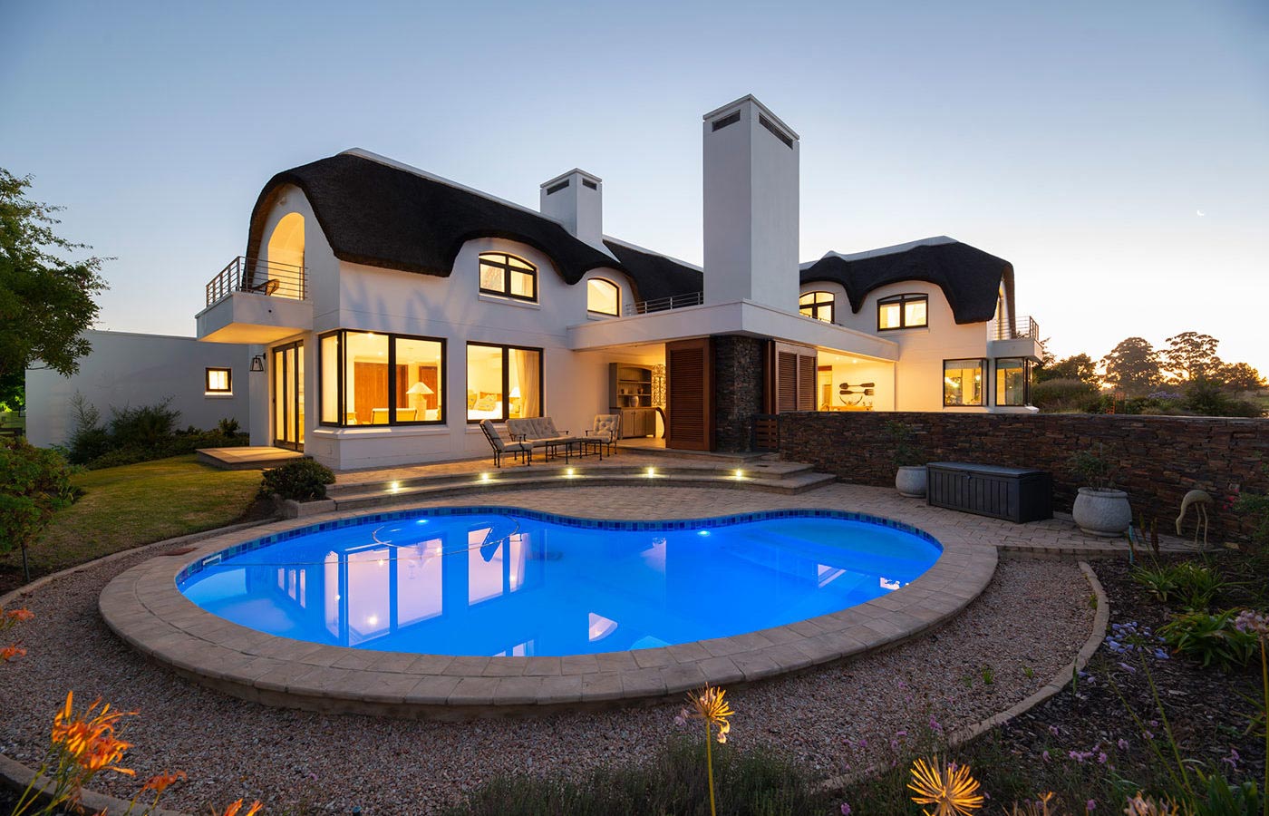 Exterior view with pool, luxury villa designed by FC Holm