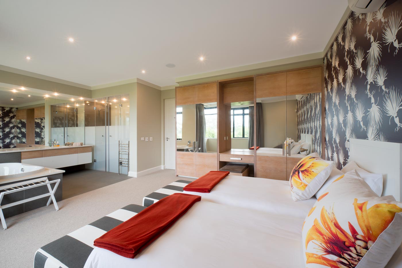 Master suite with open bathroom mirrored wardrobes and patterned feature wall