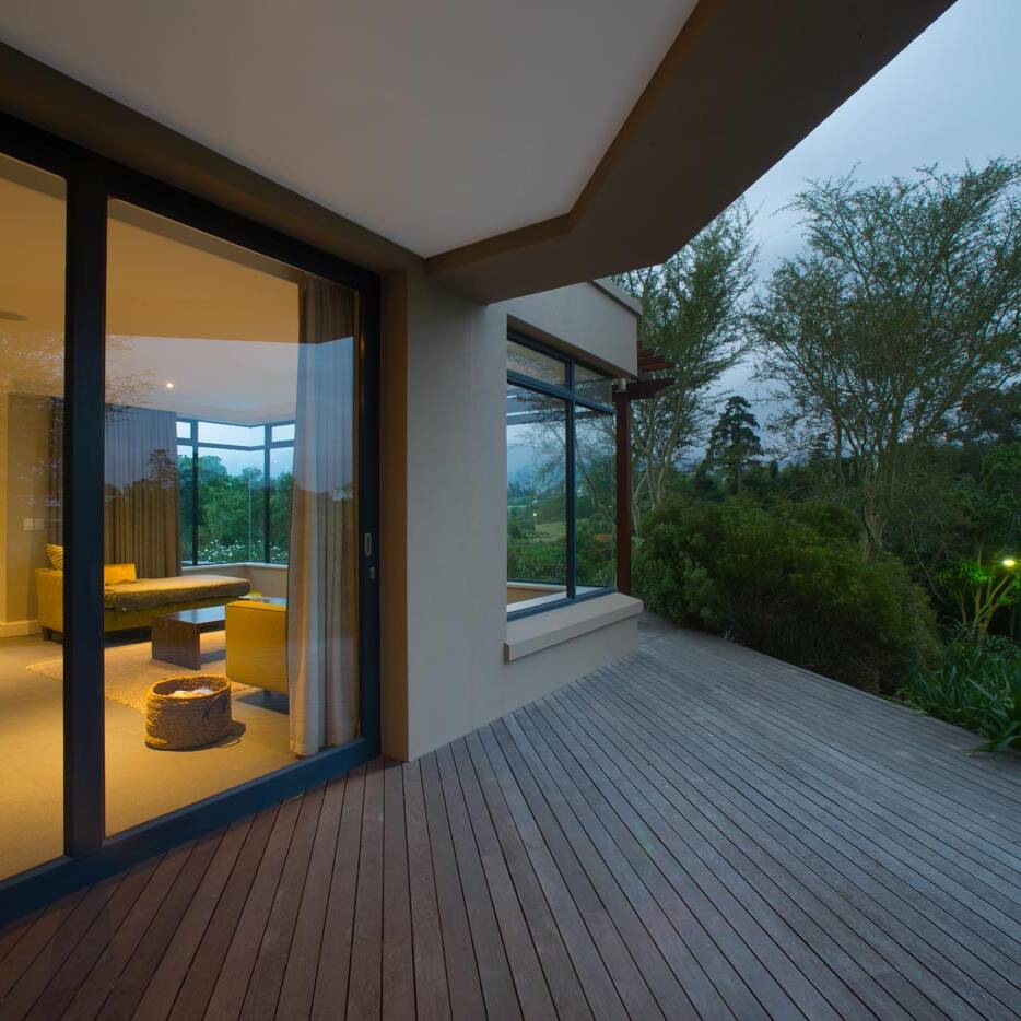 Covered veranda with outdoor seating opening to garden and timber deck