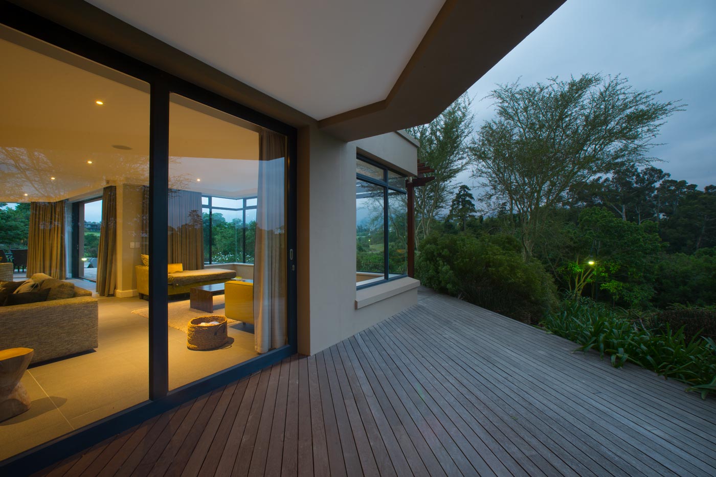 Covered veranda with outdoor seating opening to garden and timber deck