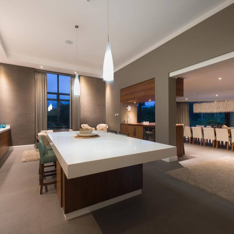 Contemporary kitchen with island breakfast bar and seating nook near tall window