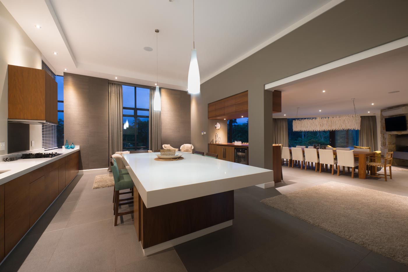 Contemporary kitchen with island breakfast bar and seating nook near tall window