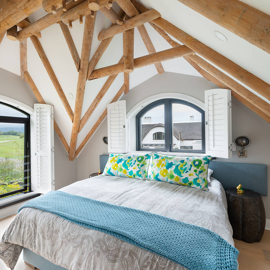 Bedroom with exposed trusses