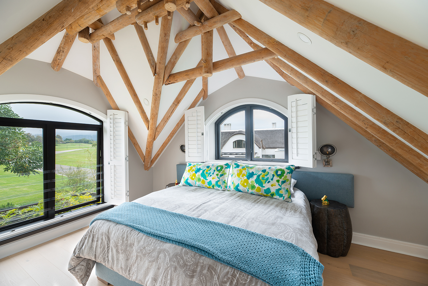Bedroom with exposed trusses