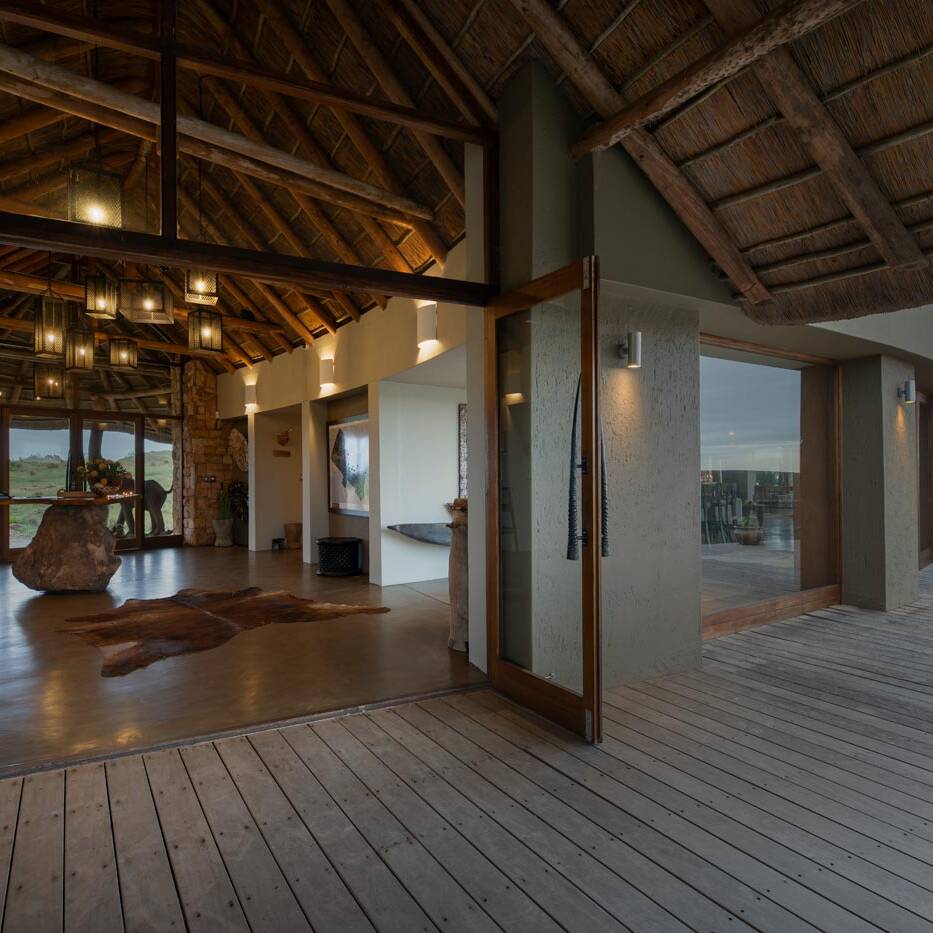 Entrance veranda with open glass doors and timber ceiling leading to the reception area