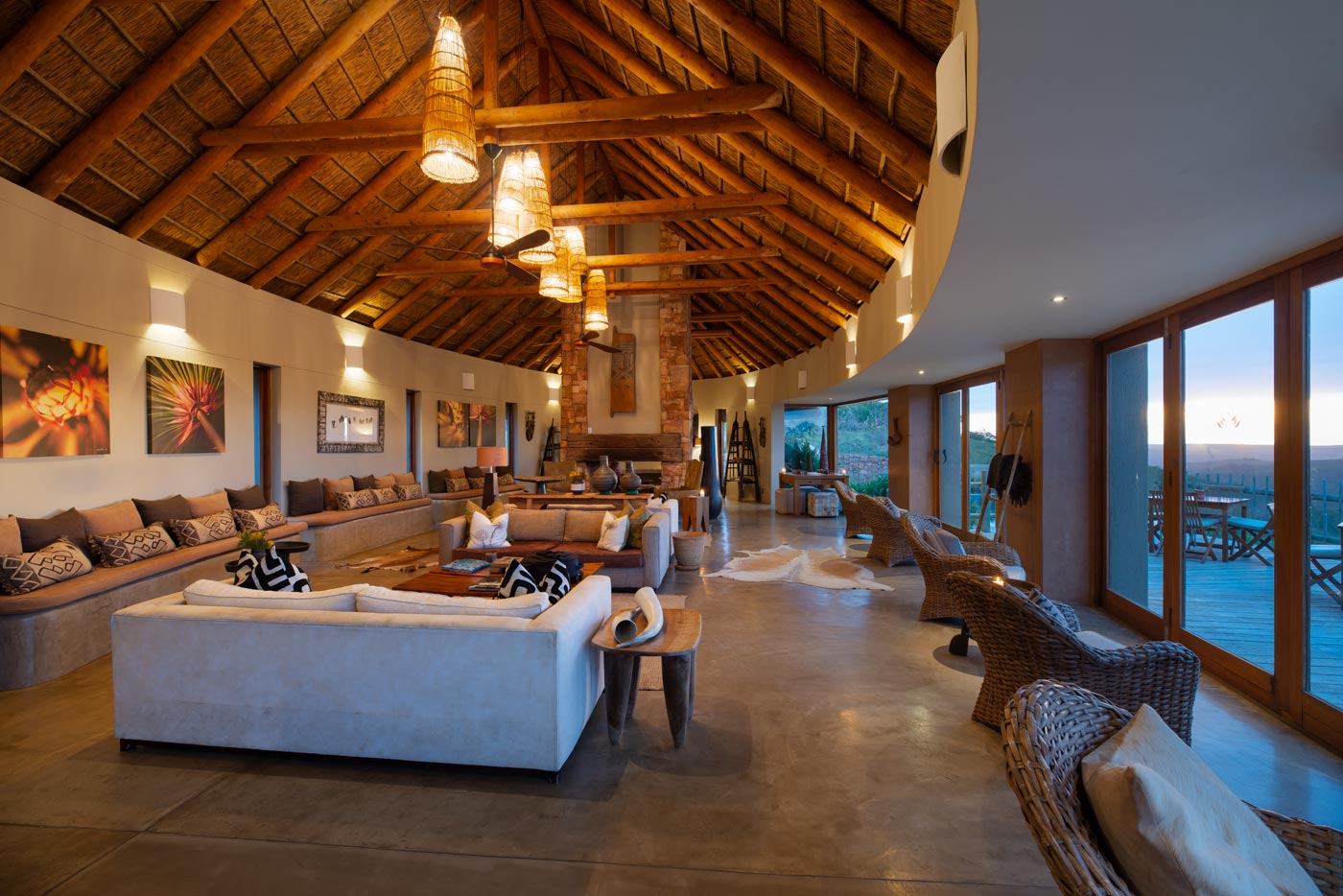 Lodge foyer with thatched roof lanterns and a stone feature wall in the Garden Route