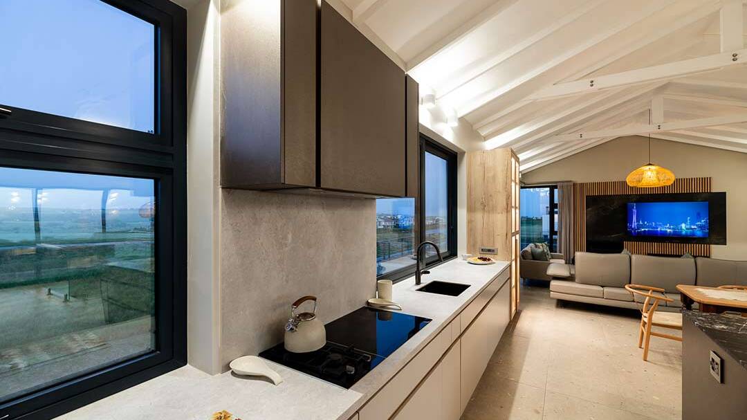 Galley kitchen opening to views and terrace