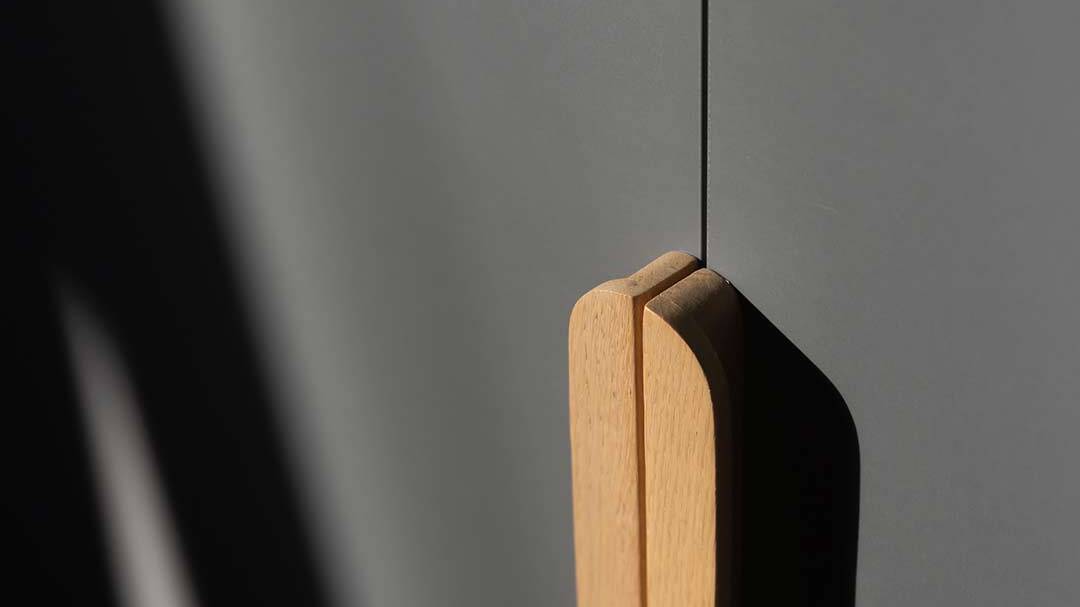 Custom oak cabinet handle detail for golf estate architecture in Oubaai