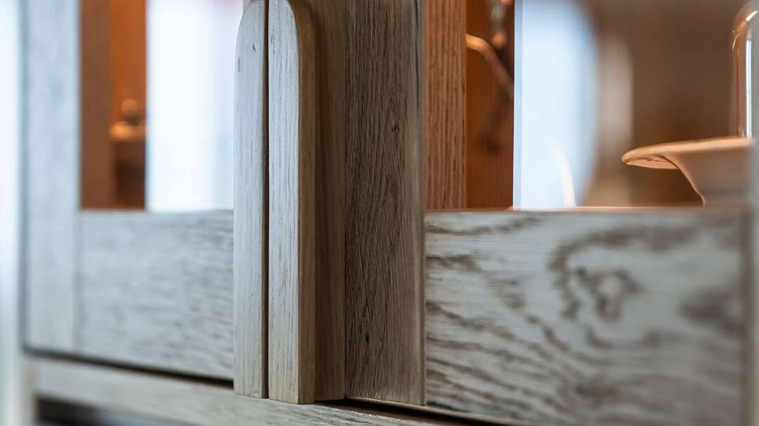 Profile-inspired timber pull on matte cabinet