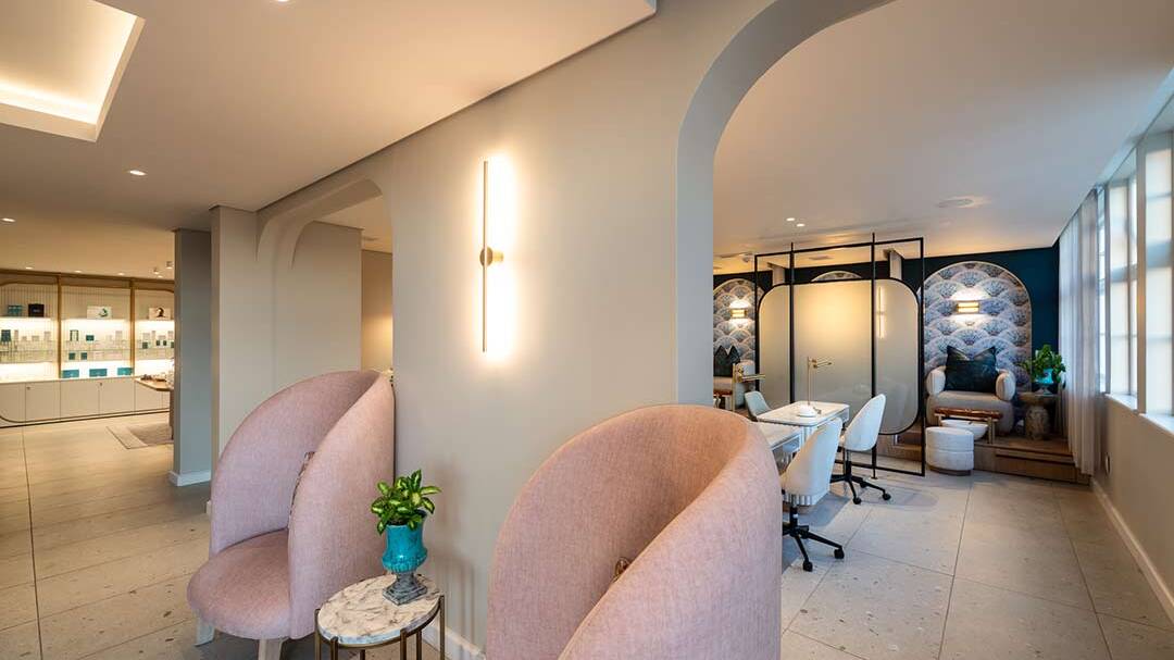 Reception lounge and manicure area with soft arches and seating