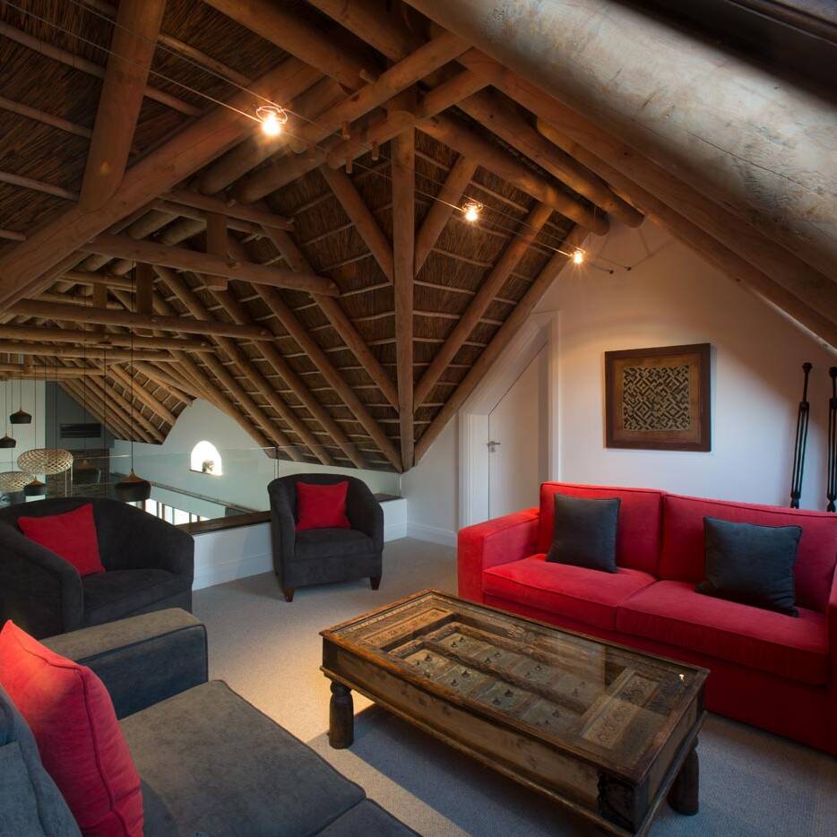 Loft with exposed trusses in estate home, South Africa
