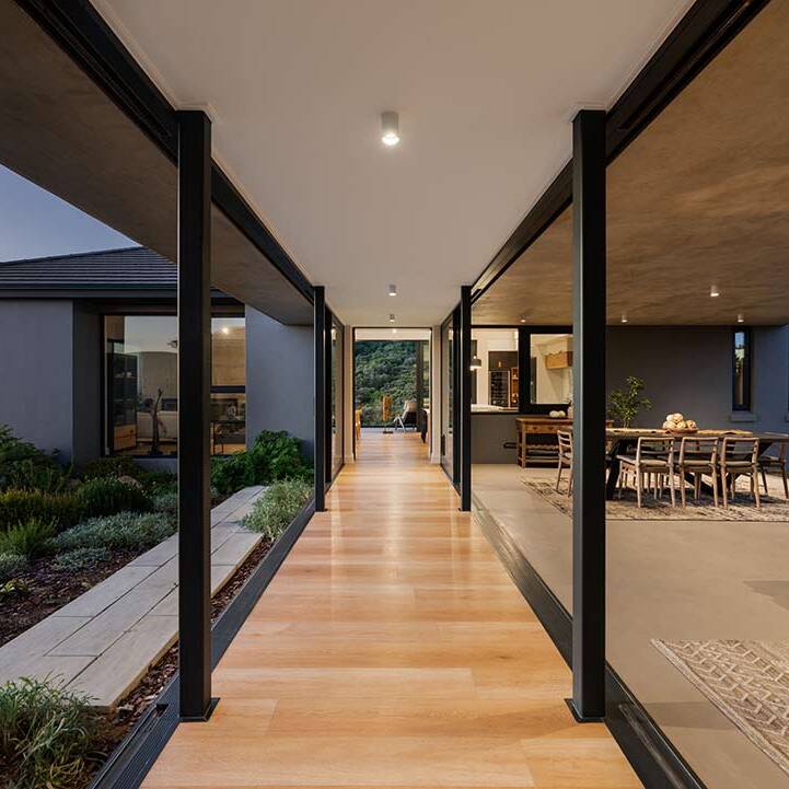 Glass-walled corridor linking two wings and opening to covered stoep, House 1418