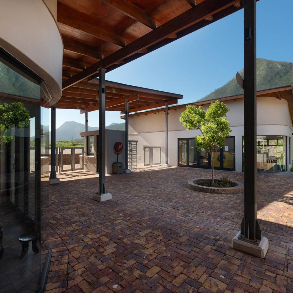 Internal courtyard with steel columns timber roof retail fronts and brick paving