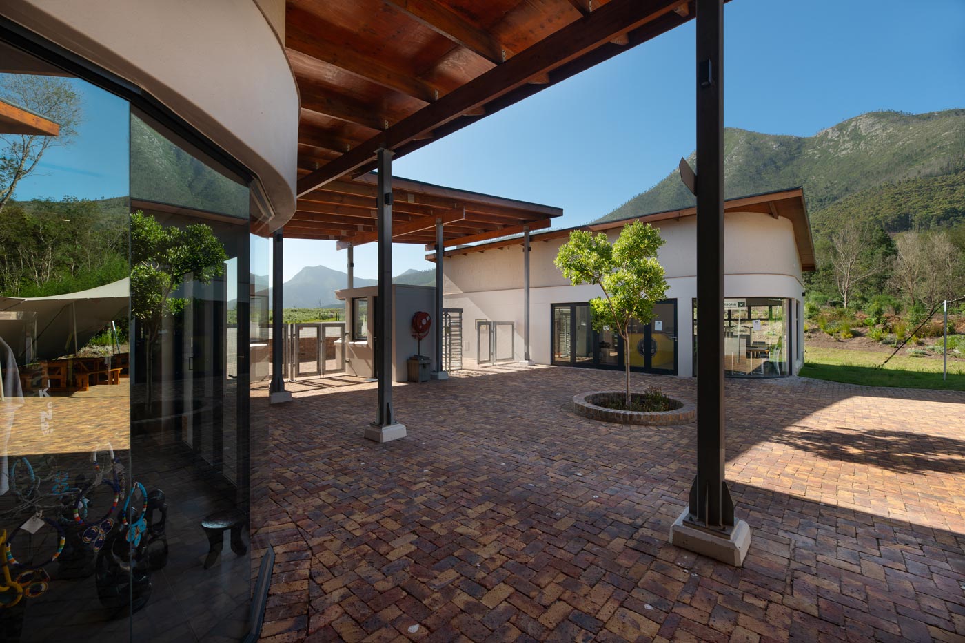 Internal courtyard with steel columns timber roof retail fronts and brick paving